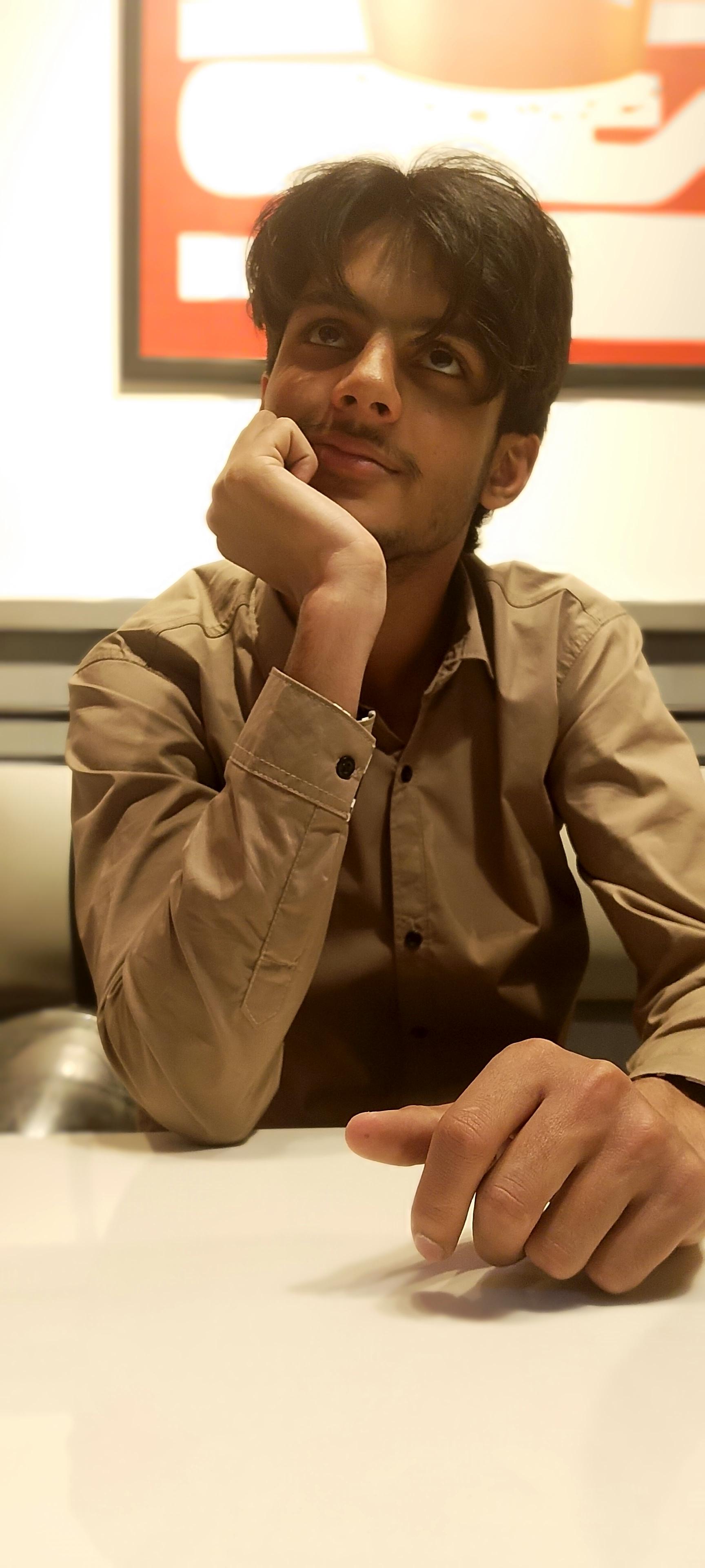 Muhammad Umer Aziz deep in thought while working at his desk — frontend engineer
